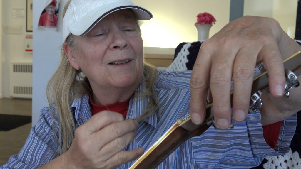 CATHY STRINGING GUITAR 3
