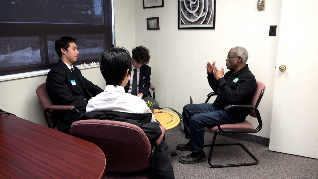 The students interview Tomlin about his life.